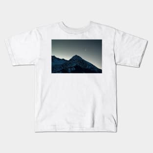 Dawn approaching behind the mountains Kids T-Shirt